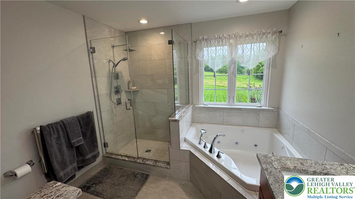 135 Clover Hollow Road Easton, PA 18045 - Photo 15 of 66 a bathroom with a tub a window and a shower