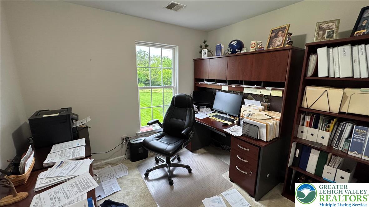 135 Clover Hollow Road Easton, PA 18045 - Photo 20 of 66 a view of a workspace with furniture and a bookshelf