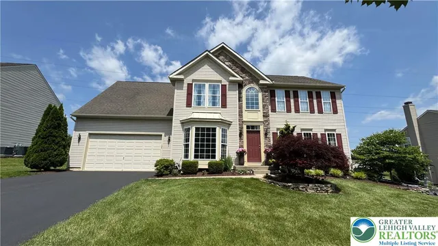 a front view of a house with a yard and garage