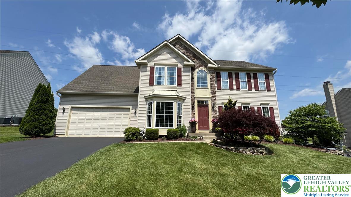 135 Clover Hollow Road Easton, PA 18045 - Photo 2 of 66 a front view of a house with a yard and garage