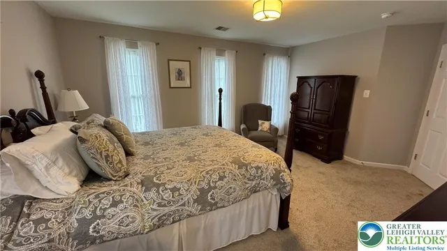 a bedroom with a bed and a mirror