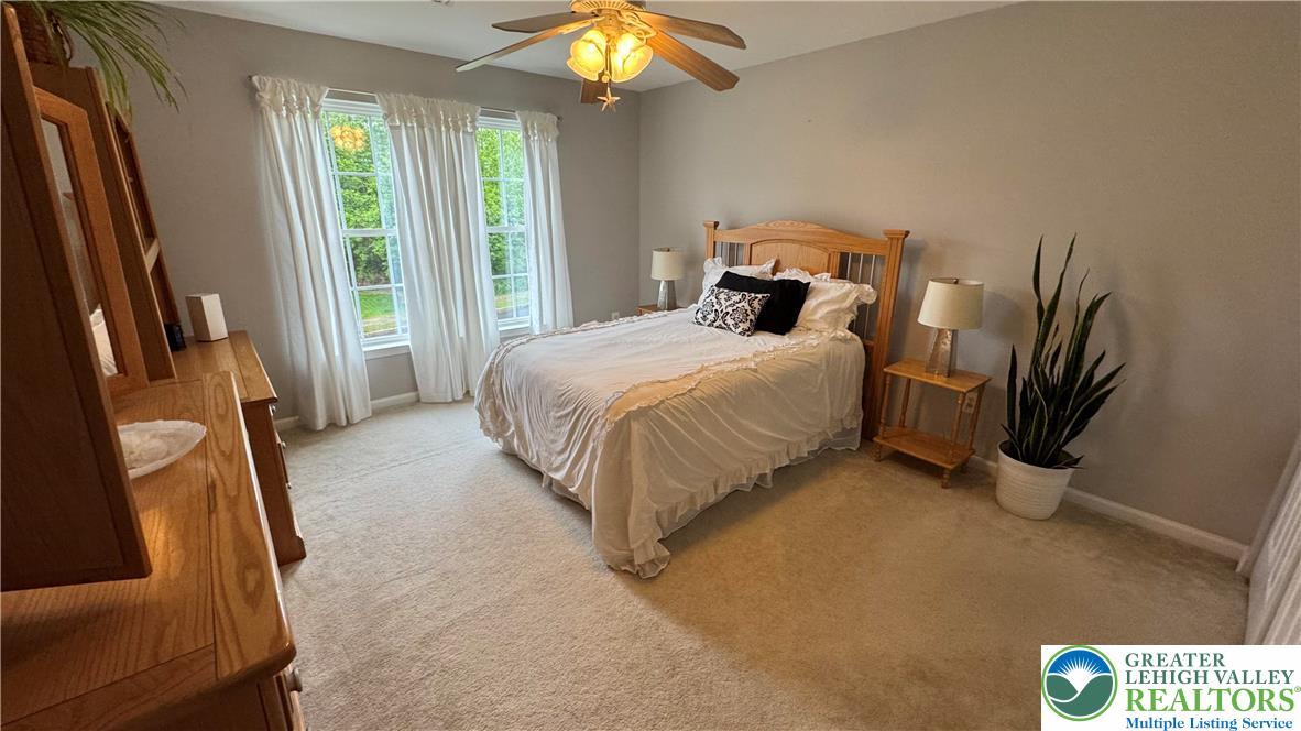 135 Clover Hollow Road Easton, PA 18045 - Photo 24 of 66 a bedroom with a bed and a chandelier