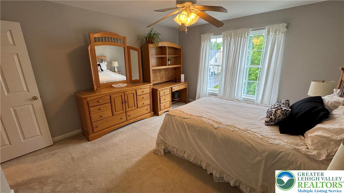 135 Clover Hollow Road Easton, PA 18045 - Photo 26 of 66 a spacious bedroom with a bed and a mirror on dresser