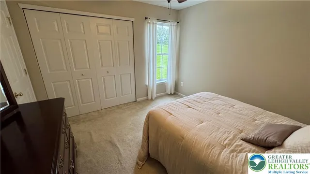 a view of a bedroom with furniture and a window