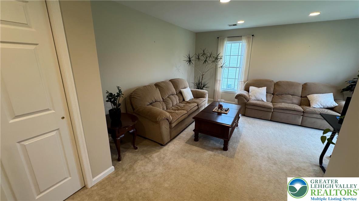 135 Clover Hollow Road Easton, PA 18045 - Photo 32 of 66 a living room with furniture and a rug