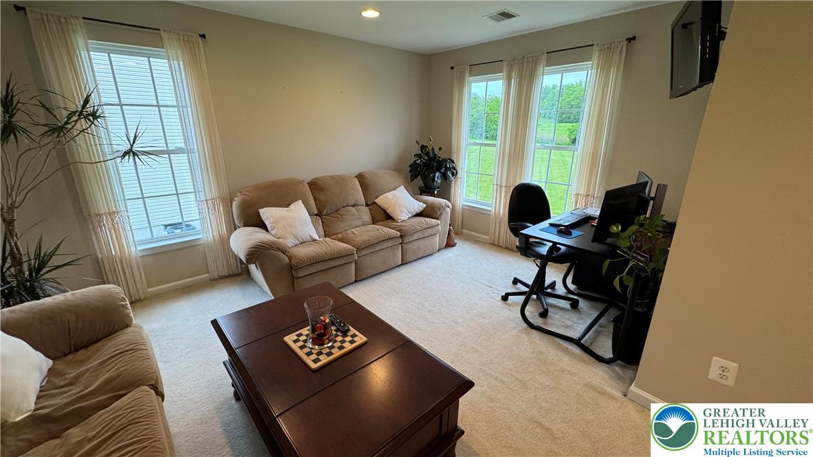 135 Clover Hollow Road Easton, PA 18045 - Photo 33 of 66 a living room with furniture and floor to ceiling windows