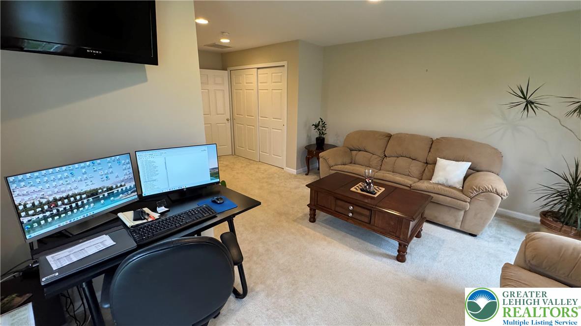 135 Clover Hollow Road Easton, PA 18045 - Photo 35 of 66 a living room with furniture and a flat screen tv