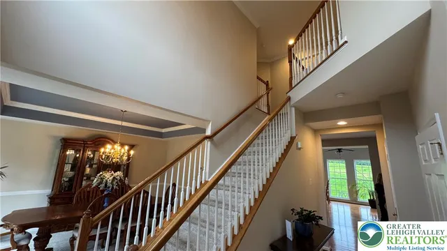 a kitchen with stainless steel appliances granite countertop a stove top oven a refrigerator a dining table and chairs with wooden floor