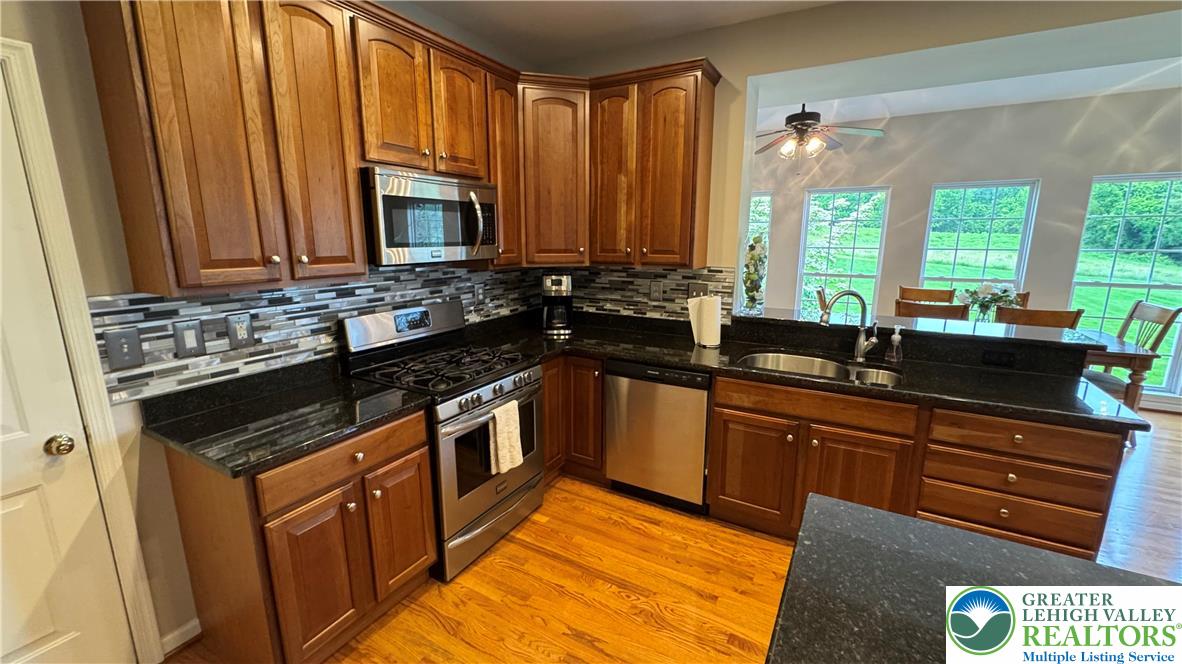 135 Clover Hollow Road Easton, PA 18045 - Photo 50 of 66 a kitchen with stainless steel appliances a sink stove and cabinets