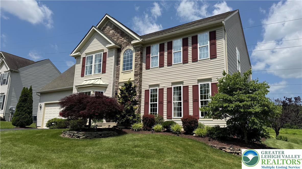 135 Clover Hollow Road Easton, PA 18045 - Photo 5 of 66 a front view of a house with a garden and plants