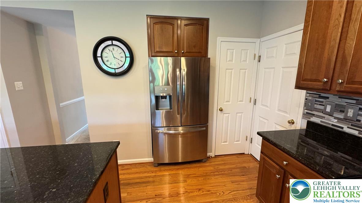 135 Clover Hollow Road Easton, PA 18045 - Photo 51 of 66 a kitchen with stainless steel appliances granite countertop a refrigerator and a stove top oven