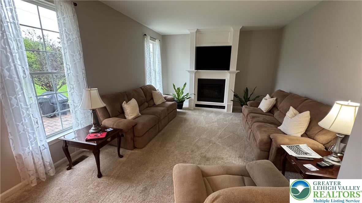 135 Clover Hollow Road Easton, PA 18045 - Photo 57 of 66 a living room with furniture a fireplace and a flat screen tv
