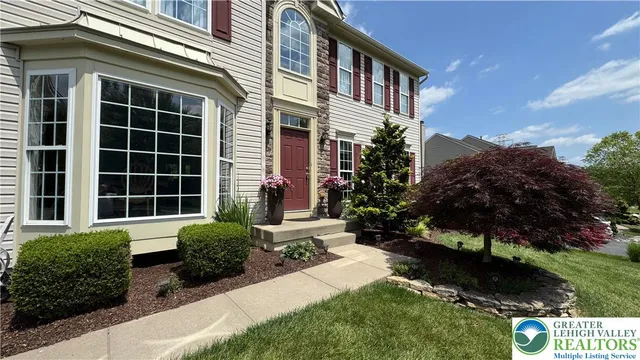a front view of a house with a yard