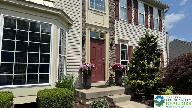 a front view of a house with a garden