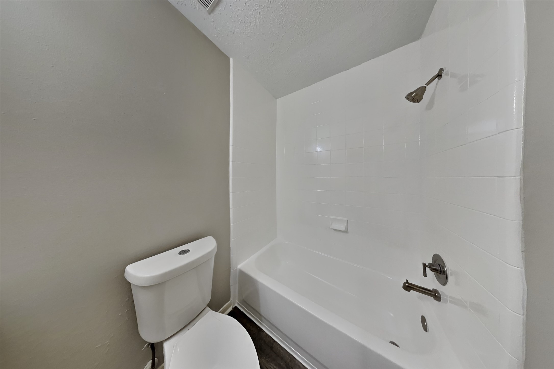 3413 Jan Court Katy, TX 77493 - Photo 15 of 18 a white toilet sitting next to a bath tub