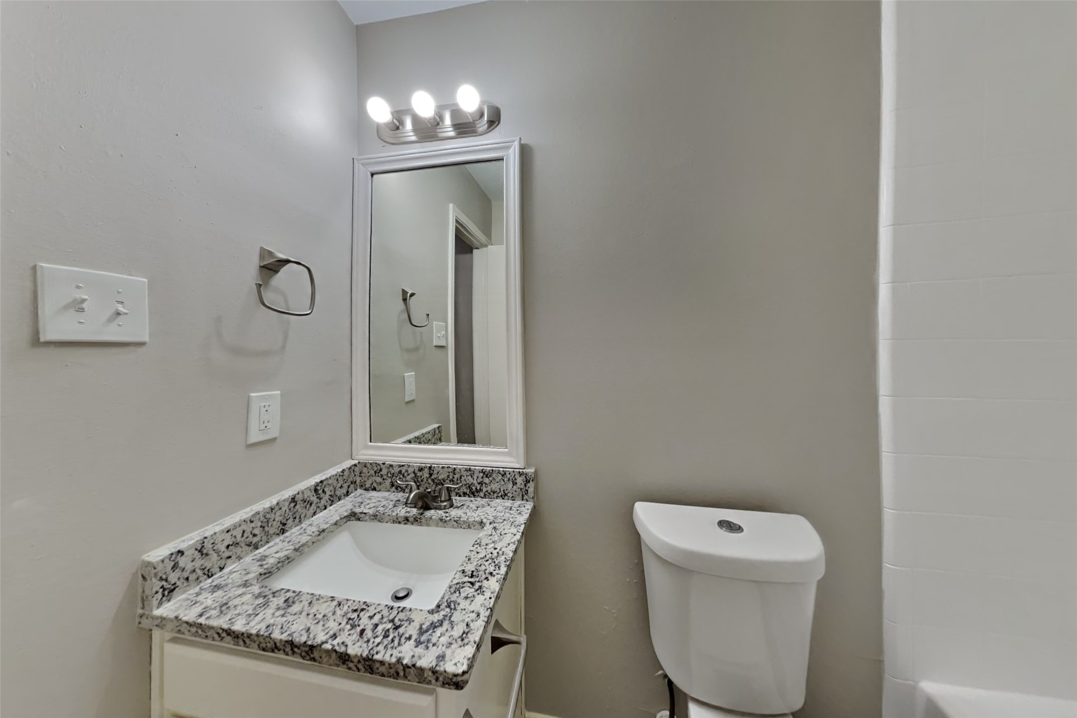 3413 Jan Court Katy, TX 77493 - Photo 16 of 18 a bathroom with a granite countertop sink a toilet and mirror