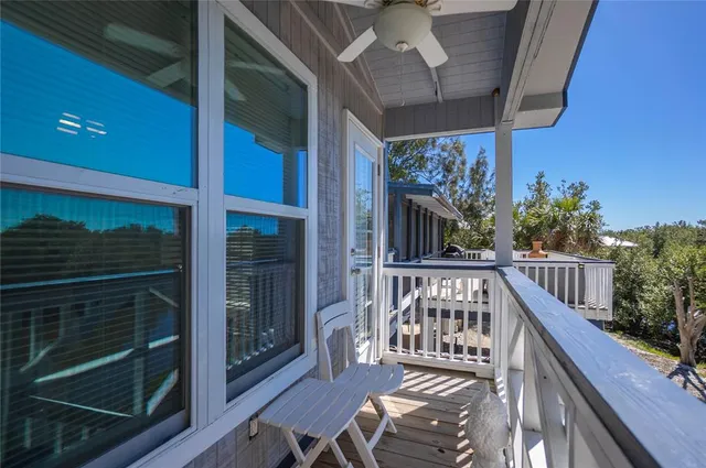 a front view of a house with a garden and lake view