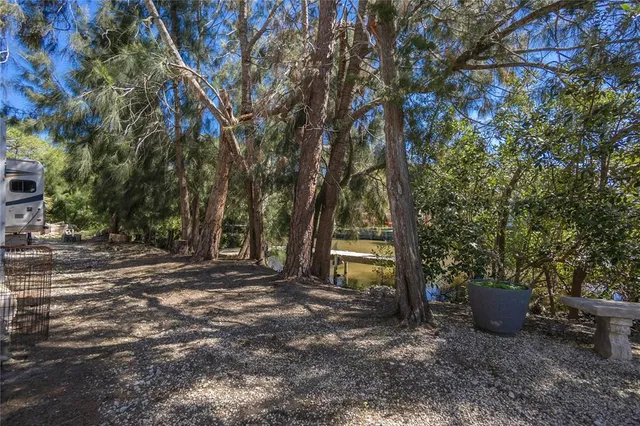 an aerial view of a house with a yard and lake view