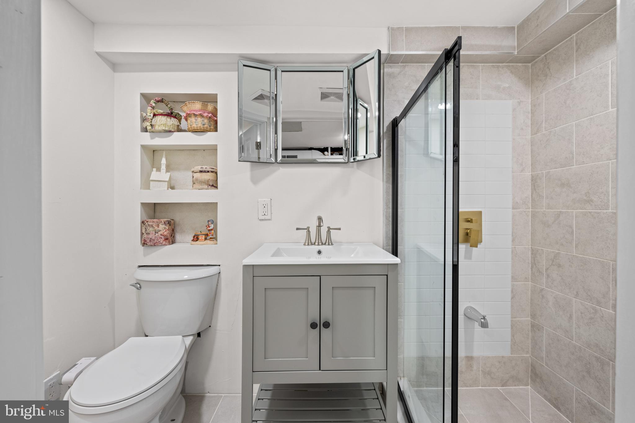 121 Cleveland Avenue Riverside, NJ 08075 - Photo 32 of 35 a bathroom with a toilet a sink and mirror