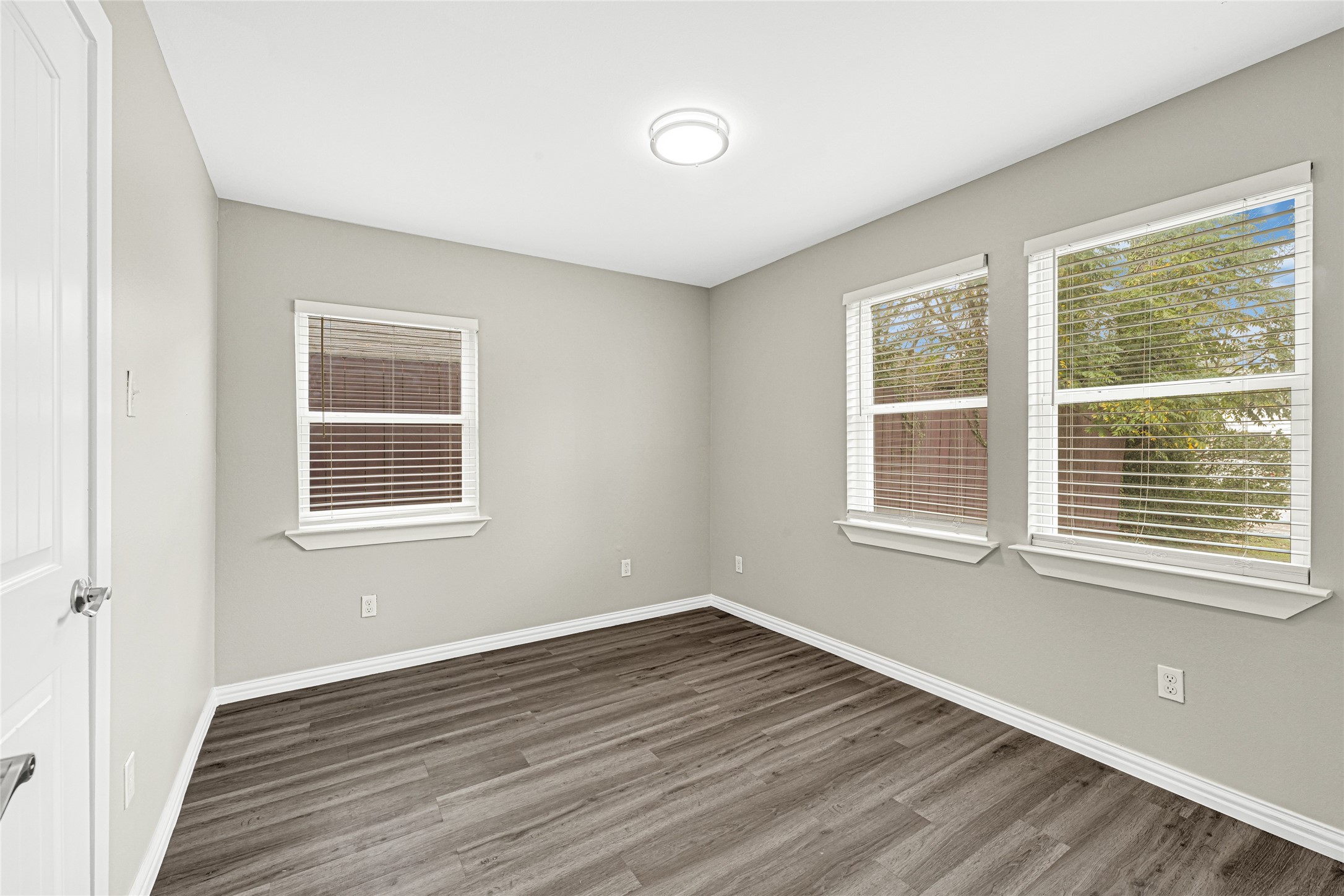 4326 Alconbury Lane, Unit 8 Houston, TX 77021 - Photo 22 of 28 a view of an empty room with wooden floor and a window