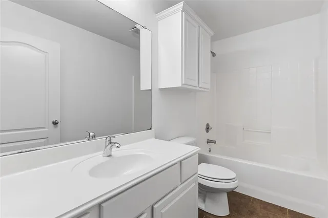 a bathroom with a sink toilet and vanity