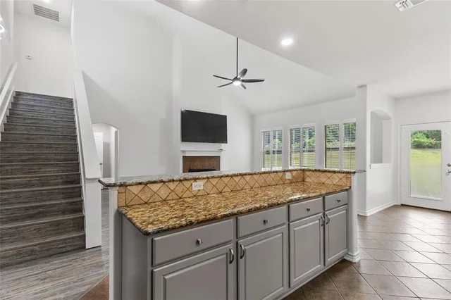 a view of living room with granite countertop furniture and fireplace