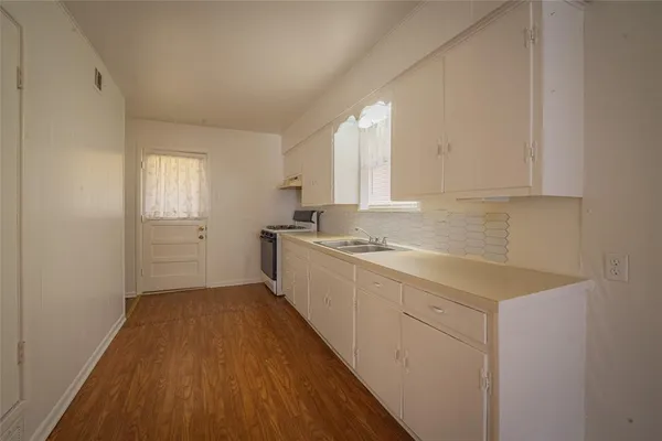 a kitchen with granite countertop a stove and a refrigerator