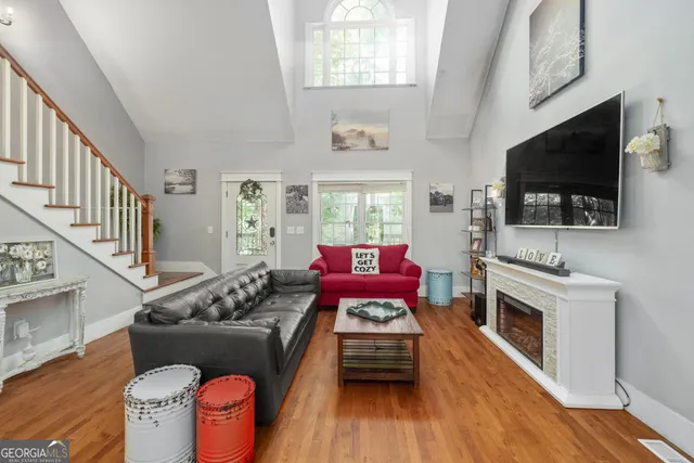 a living room with furniture fireplace and flat screen tv