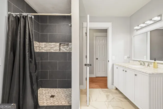 a bathroom with a shower and a sink