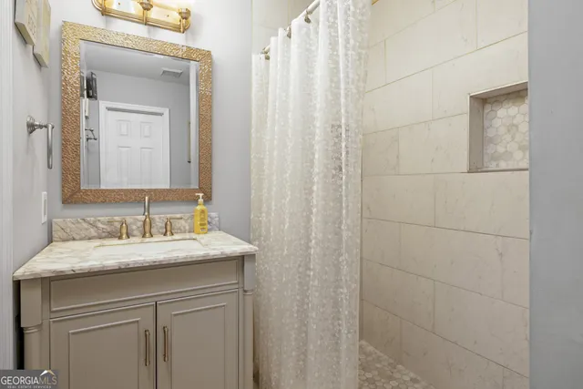 a bathroom with a granite countertop sink and a mirror