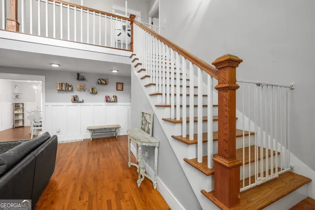 a bathroom with a granite countertop sink a mirror and a shower