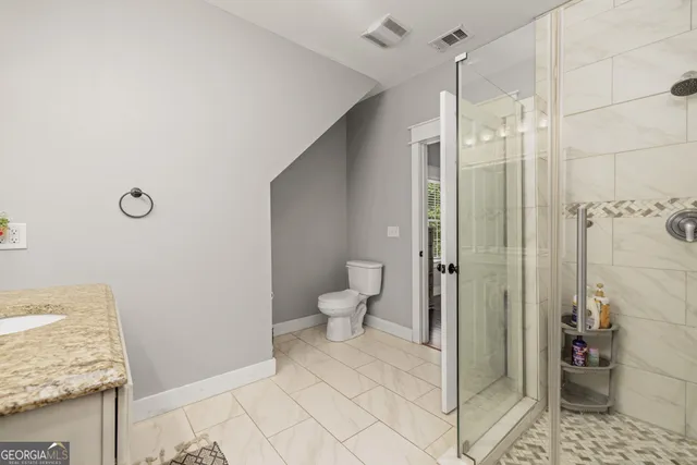 a bedroom with a bed and a flat tv screen on dresser