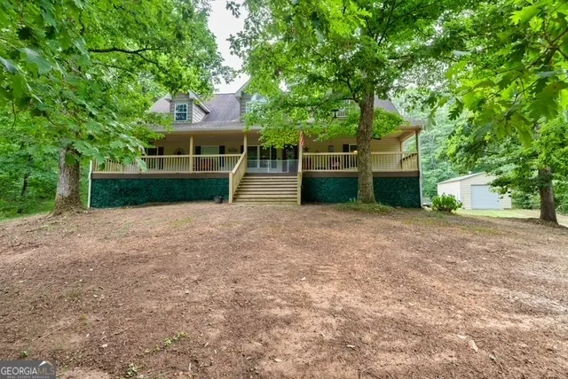 an aerial view of a house with a yard and lake view