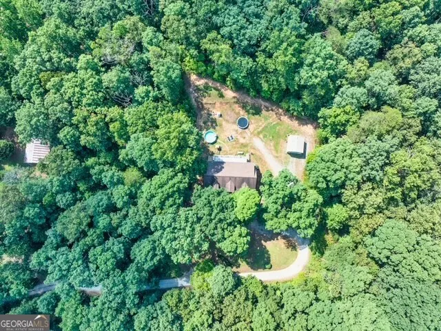 an aerial view of a house with swimming pool patio and outdoor seating
