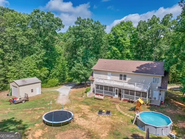 a view of a house with a yard and sitting area