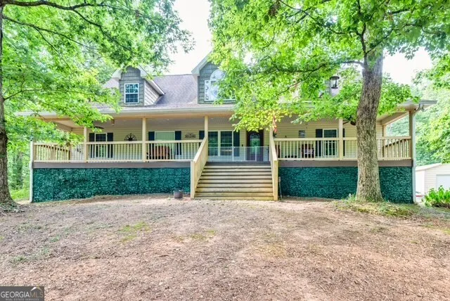 a front view of a house with a yard and trees