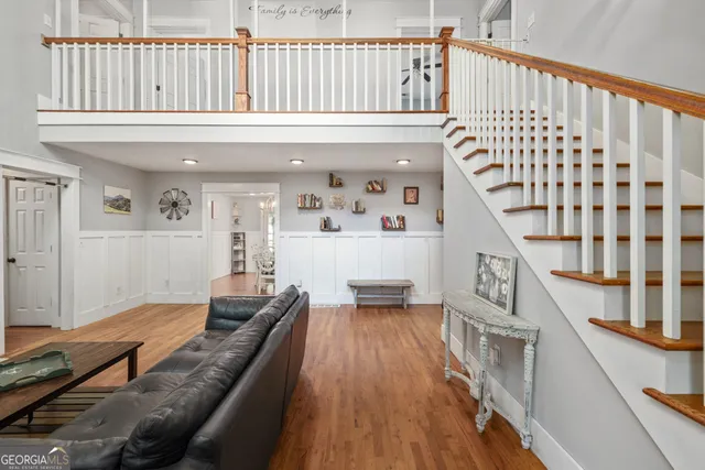 a living room with furniture and wooden floor