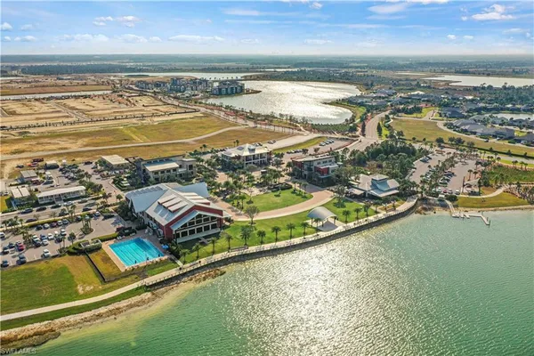 an aerial view of a building with swimming pool and outdoor space