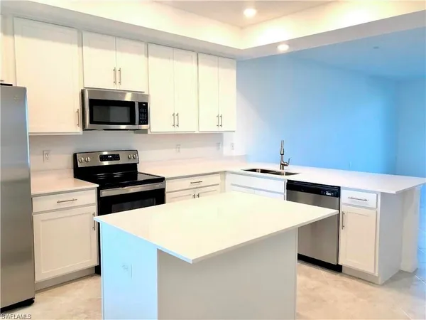 a kitchen with a stove and a microwave