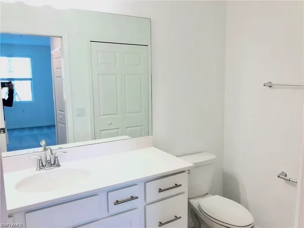 a bathroom with a sink a toilet and vanity