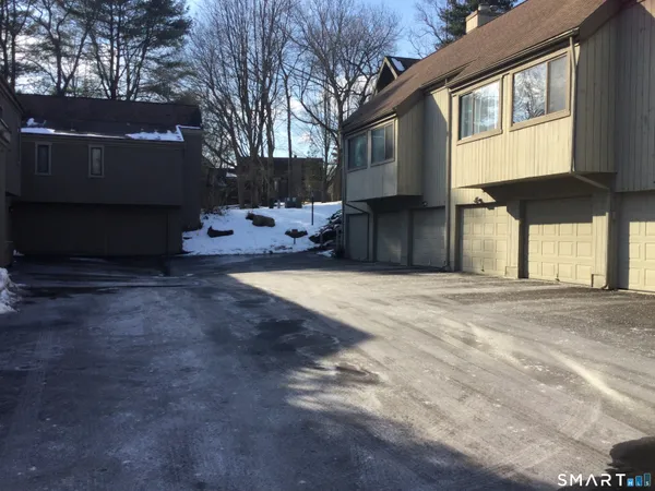 a view of a house with a yard covered in snow