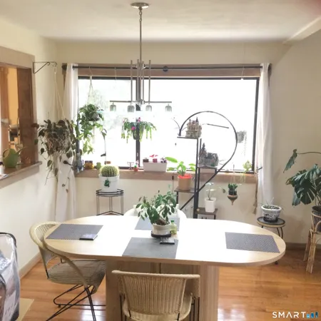a dining room with furniture and window