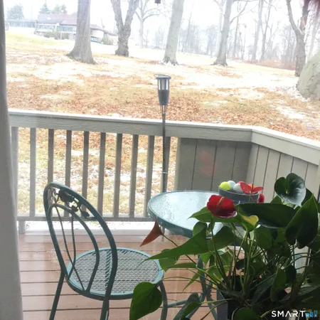 a view of a chairs and table in patio