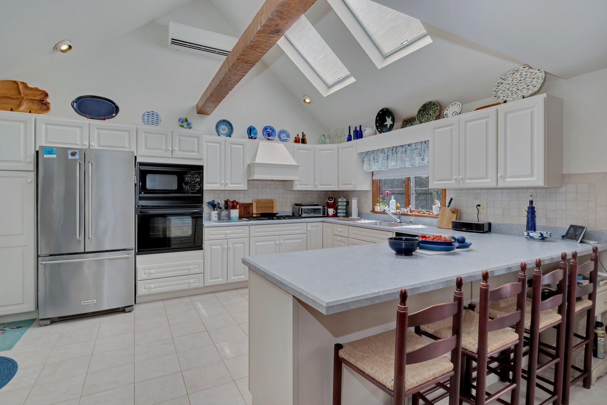 106 Castle Road Truro, MA 02666 - Photo 17 of 47 a kitchen with stainless steel appliances granite countertop a sink refrigerator and cabinets