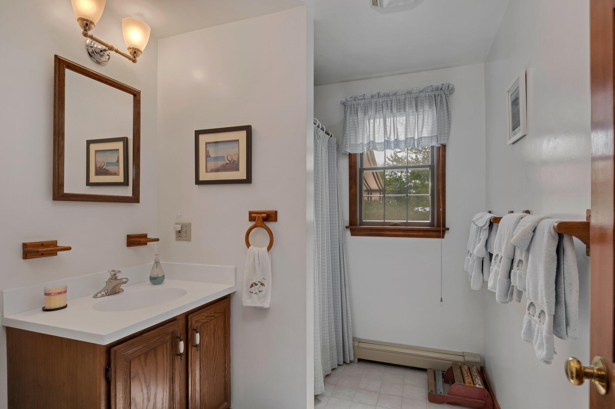 106 Castle Road Truro, MA 02666 - Photo 21 of 47 a bathroom with a sink and mirror