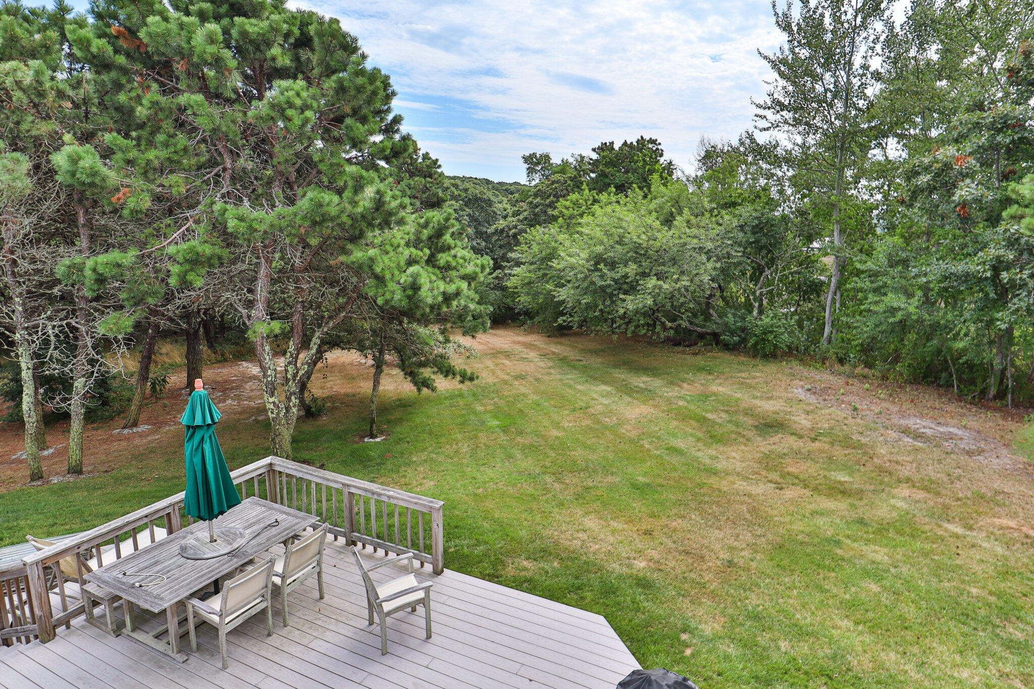 106 Castle Road Truro, MA 02666 - Photo 32 of 47 a view of a table and chairs on the deck