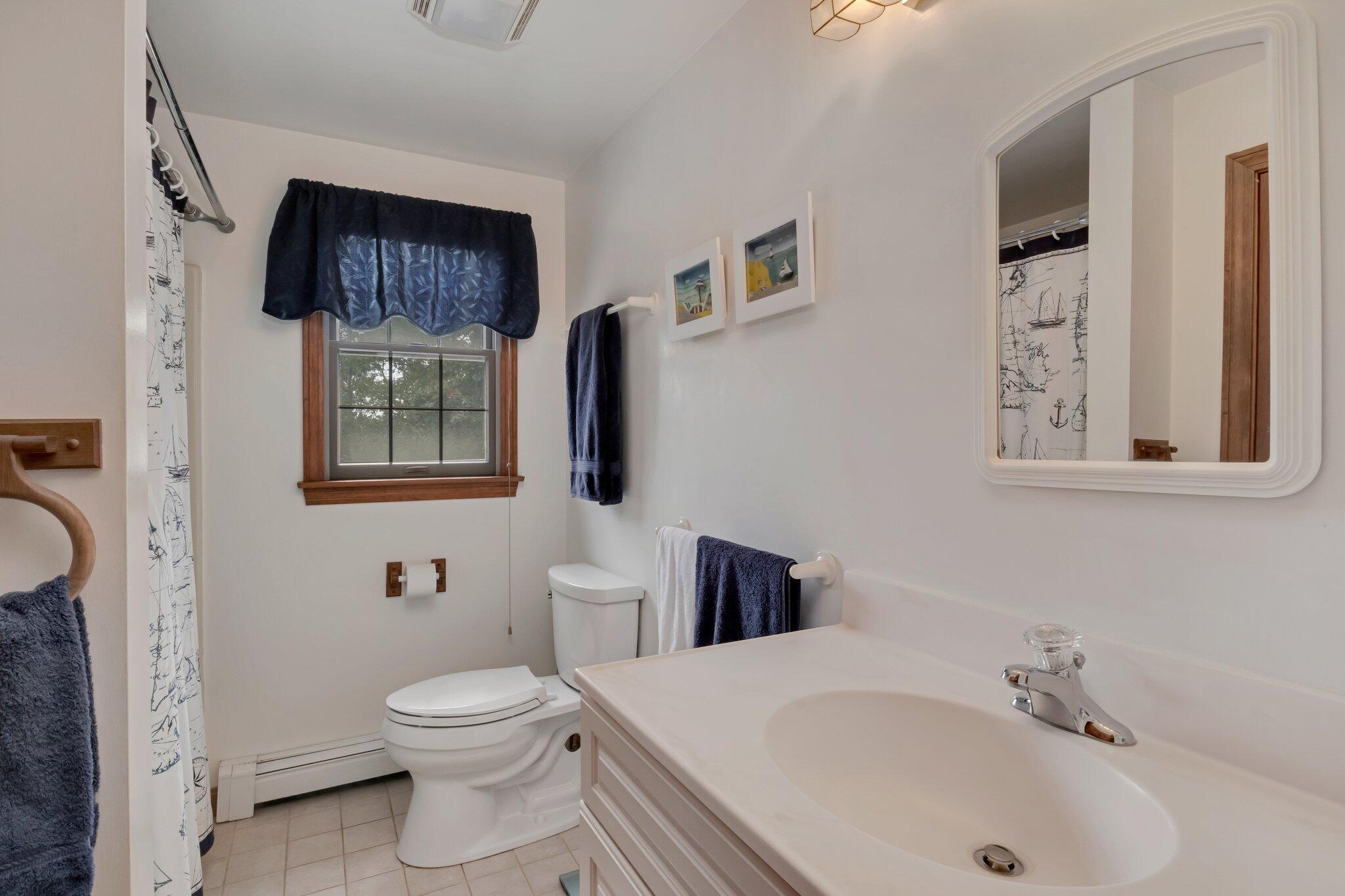 106 Castle Road Truro, MA 02666 - Photo 34 of 47 a bathroom with a toilet sink and mirror
