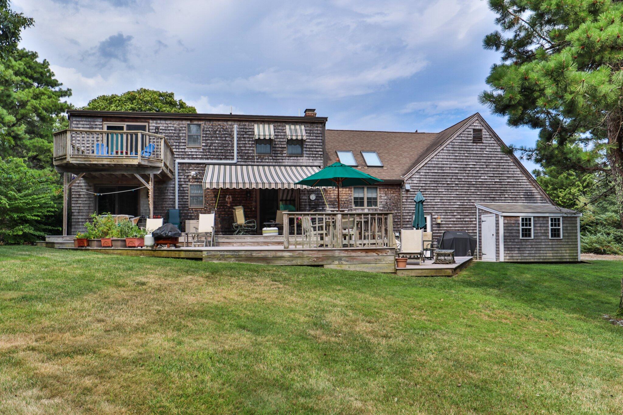106 Castle Road Truro, MA 02666 - Photo 46 of 47 a view of a house with a yard and sitting area