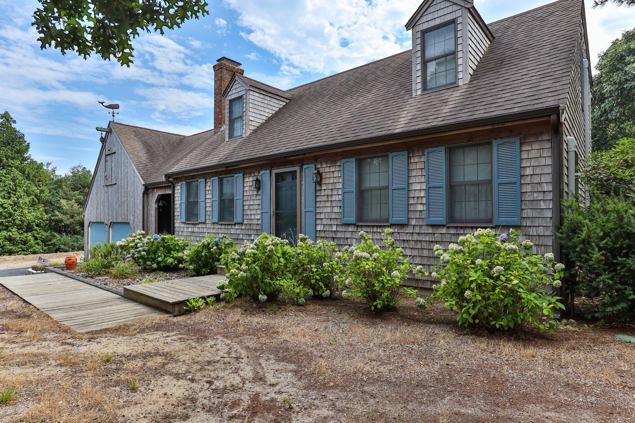 106 Castle Road Truro, MA 02666 - Photo 9 of 47 a front view of a house with garden