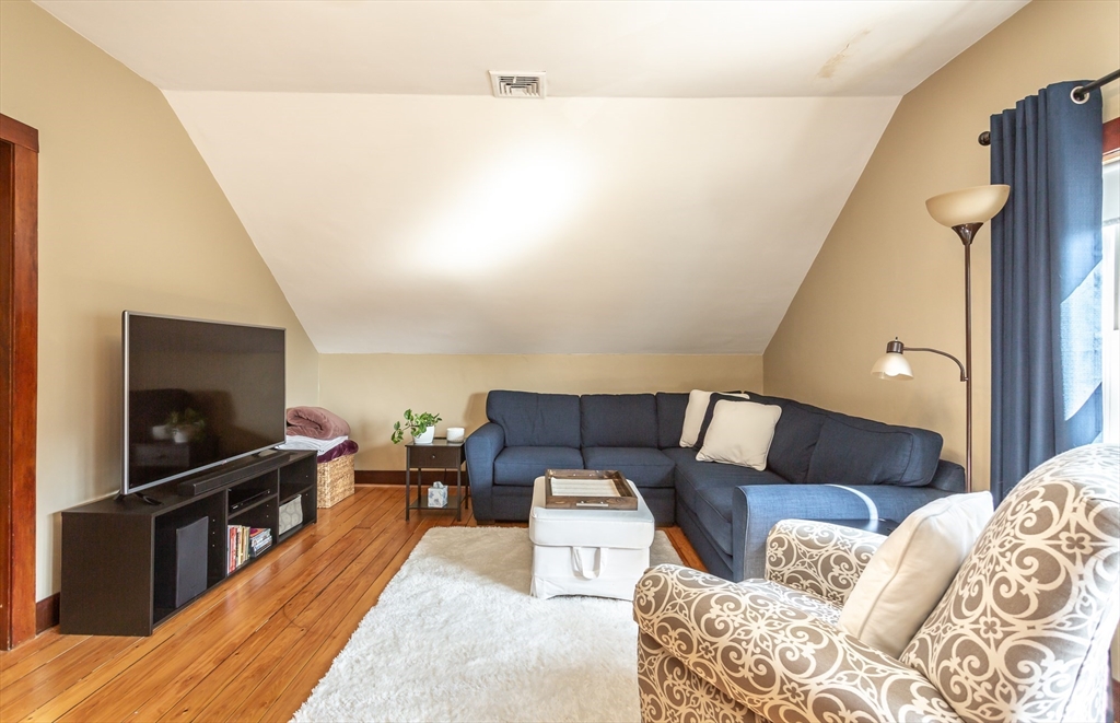 256 Maple Street Fall River, MA 02720 - Photo 30 of 41 a living room with furniture and a flat screen tv